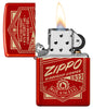 Zippo It Works Design Metallic Red Windproof Lighter with its lid open and lit.
