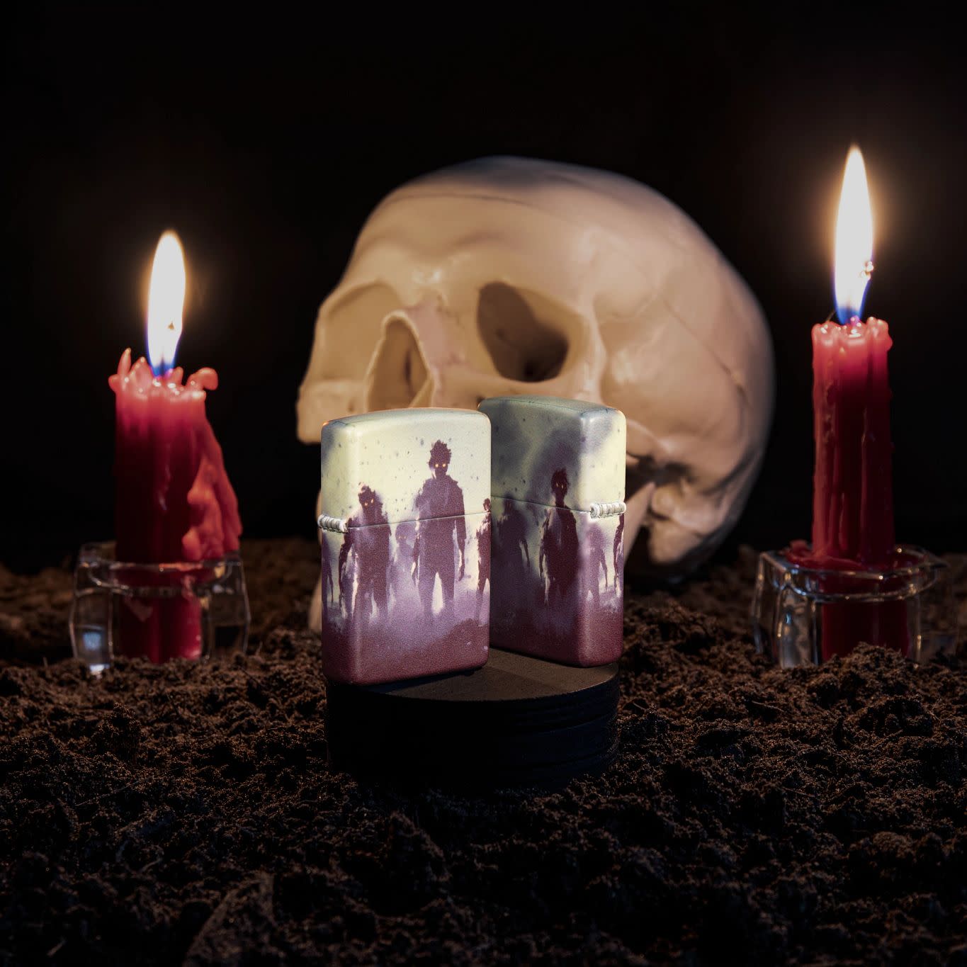 Lifestyle image of Zombie Design 540 Color Windproof Lighter with a skull and lit candles behind it.