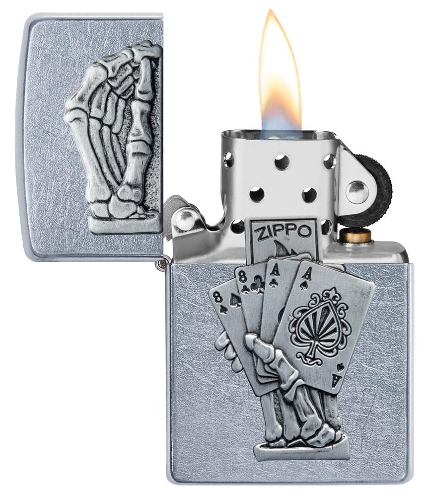 Dead Mans Hand Surprise Emblem Design Street Chrome™ Windproof Lighter with its lid open and lit