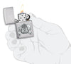 Card Skull Emblem Design Windproof Lighter lit in hand